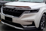 Front view of a white mini van with a black grille